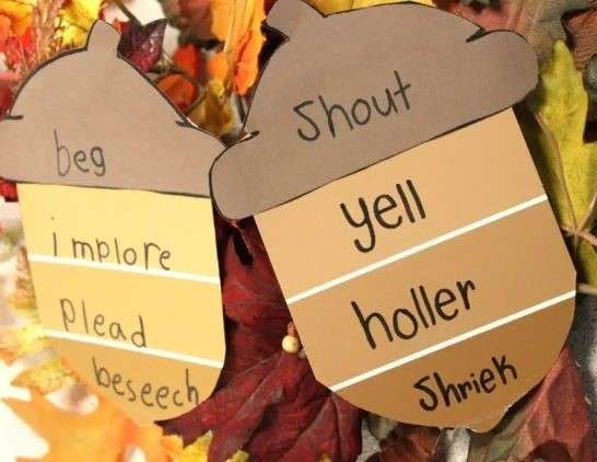 A classroom activity of english vocabulary words centered around two acorns, highlighting a fall theme with vibrant colors and seasonal decorations.