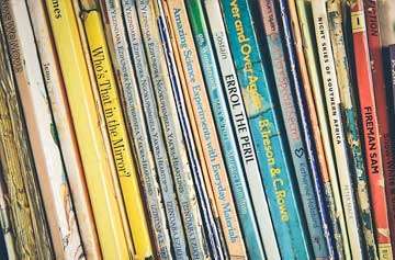 A stack of colorful books symbolizing English pronunciation & grammar resources.